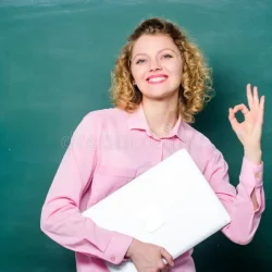 woman-cheerful-teacher-hold-laptop-stand-near-chalkboard-school-education-concept-software-teachers-modern-lecturer-164118108